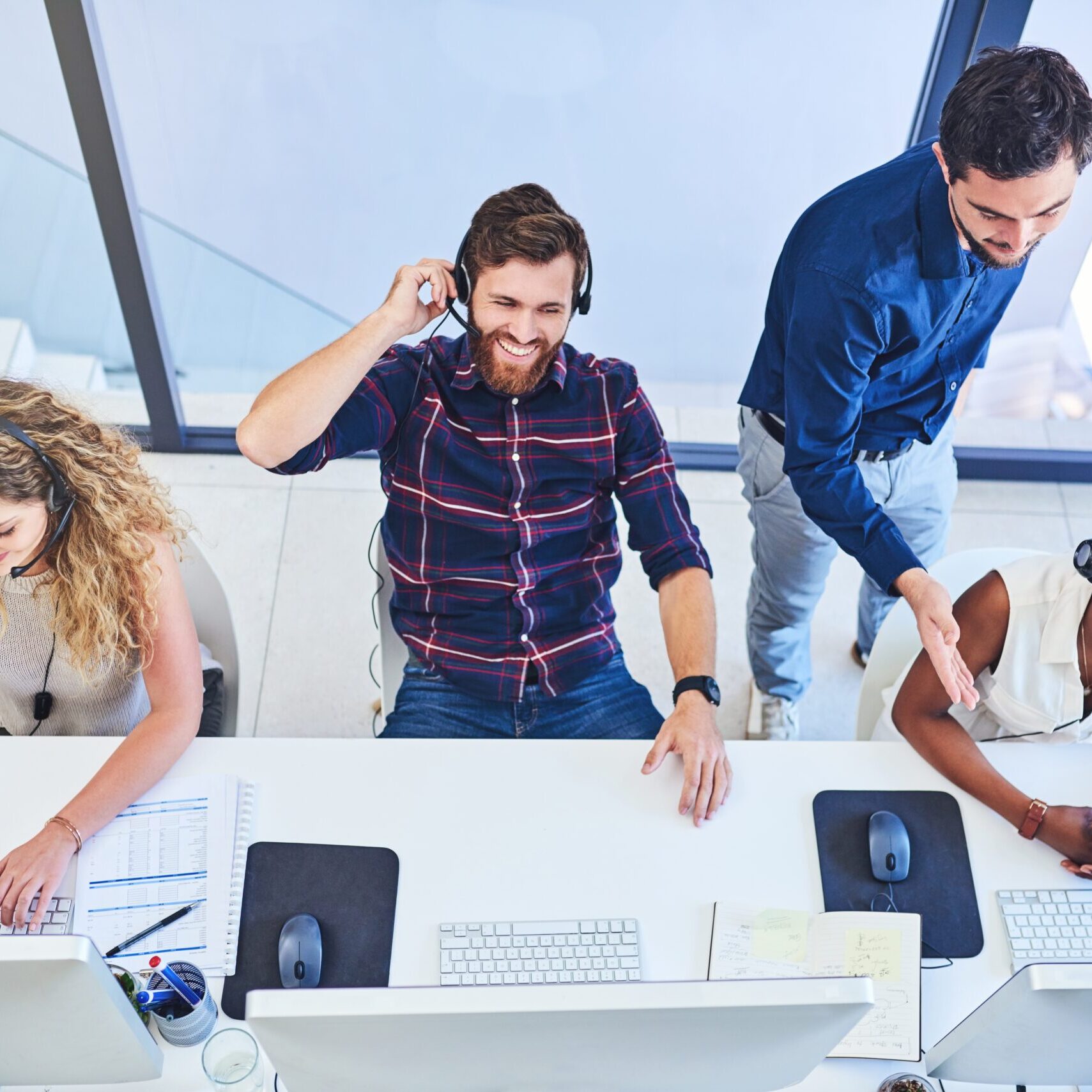 High angle shot of a team of young people working in a call centre